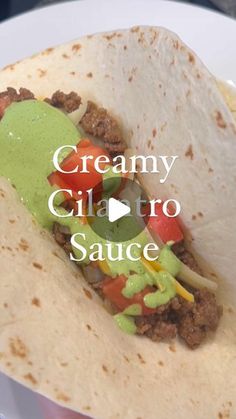 a close up of a taco on a plate with the words creamy clattro sauce