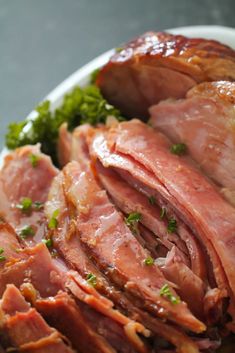 ham and broccoli on a white plate with parsley in the middle, ready to be eaten