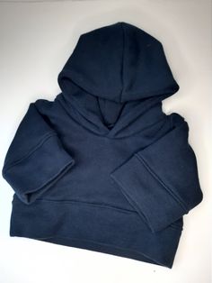 a blue hoodie sitting on top of a white table