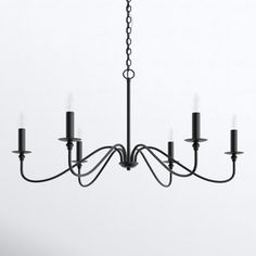 a black chandelier with five candles hanging from it's center and four arms