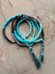 Set of 5 Boho dainty beaded bracelets, stack and layer them all. 7-inch length, elastic band. Set of 5 bracelets Beaded Bracelets With Tassels For Beach, Turquoise Beaded Necklace With Tassels And Round Beads, Gift Bracelet With Tassels And Round Beads, Turquoise Beaded Necklace With Tassels, Gift Bracelets With Tassels, Adjustable Bracelets With Tassels And Round Beads, Adjustable Round Beads Bracelets With Tassels, Adjustable Tassel Bracelets With Round Beads, Bracelets Stack