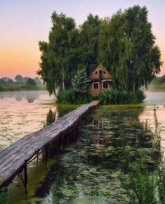 an instagram with a house on the water and a dock in front of it