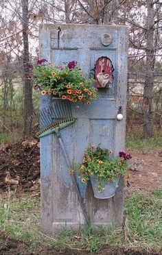 an old blue door with flowers growing out of it and the words garden decoration above it