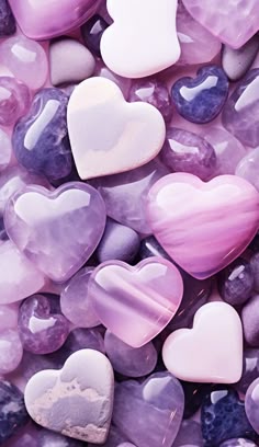 purple and white heart shaped rocks are on the ground with other hearts in it's center