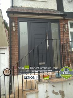 an image of a black door on the side of a house that is for sale