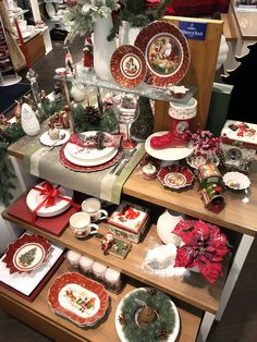 a christmas display in a store filled with plates and dishes