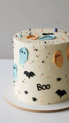 a white cake with halloween decorations on it