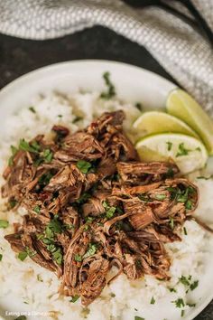 shredded beef and rice on a plate with lime wedges