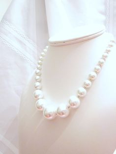 "Beautiful white graduated glass pearls and petite silver spacers were used to make this simple yet elegant necklace.  Perfect for a wedding! The necklace is ~16-17\" long.  It has a silver plated lobster claw clasp and 2.5\" chain extender. Customize this one! This style is available in various colors, and lengths, just convo. with your requests.  Perfect for brides and bridesmaids!  Bridal party discounts are available. Necklace created with: 6mm, up to 18mm white glass Pearls, and 2.4 mm silver round spacers. Shipping to the US is via USPS Priority Mail, unless another method is requested. Shipping to other countries will be actual shipping charges for your chosen method. Please email for charges and shipping options before you check-out. Price shown below is for USPS international prio Elegant Necklace, Chain Extenders, Wedding Bridesmaid, Elegant Necklaces, Brides And Bridesmaids, Bride Wedding, White Glass, Pearl White, Bridal Party