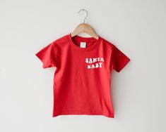 ♥ PLEASE READ ♥ Please read before placing an order.  * All of our shirts are made by me, a Swedish mama, living in Canada, with a little bit of help from my toddler assistant. * If you have any questions about our shirts, send us a message here on Etsy.  * We would love it if you followed us on instagram  @littleandswede ♥ T-SHIRT INFORMATION  * All shirts are super soft and comfortable. * Shirts are 100% Cotton except for Grey shirts that are 93% cotton and 7% polyester.  * Shirts run true to Kids Christmas Shirt, Living In Canada, Toddler Christmas Shirt, Vintage Kids Clothes, Christmas Shirts For Kids, Santa Shirts, Vintage Kids, Toddler Christmas, Unisex Baby Clothes