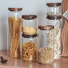 three glass jars filled with different types of food