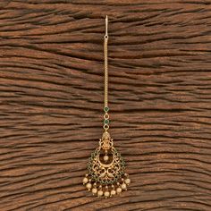 Indian Bridal Traditional One Gram Jewelry Tikka Height = 165 mm || Width = 42 mm Temple Tikka Antique Maang Tikka Whether you are the bride or sassy bridesmaid, no lehenga is complete without a maang tikka. This Kundan pearl maang tikka is perfect to steal the show with its elegance . The meticulous attention paid to the craftsmanship makes it an epitome of jewelry inspiration. 100% Satisfaction Guarantee: Long Lasting Plating, High-Quality Stones. Gifting: This pair of charming maang tikka com Festive Temple Jewelry Tikka With Stone Work, Ceremonial Temple Jewelry Tikka With Stone Work, Chandbali Stone Work Tikka In Temple Jewelry Style, Chandbali Temple Jewelry Tikka With Stone Work, Temple Style Chandbali Tikka With Stone Work, Temple Jewelry Chandbali Tikka With Stone Work, Heavy Temple Jewelry Tikka For Navratri, Temple Jewelry Tikka With Tilla For Festive Occasions, Navratri Temple Jewelry Tikka With Latkans