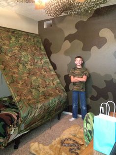 a man standing in front of a camouflage couch