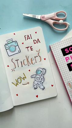 a notebook with stickers on it next to a pair of scissors