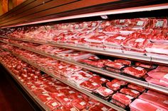 meat is displayed on shelves in a grocery store