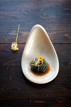 a white plate topped with food on top of a wooden table