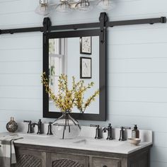 a bathroom vanity with two sinks and a mirror on the wall above it is decorated with yellow flowers