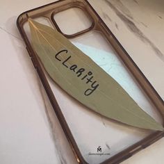 a clear case with a leaf on it that says clearly in cursive writing