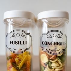 two glass jars filled with different types of pasta