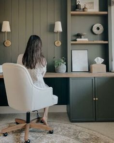 a woman sitting at a desk in an office