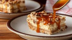 a spoon drizzling caramel sauce onto a piece of cake on a plate