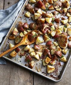 a pan filled with potatoes on top of a wooden table