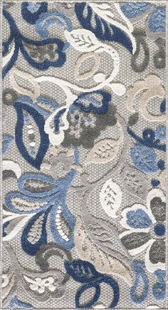 an area rug with blue and gray designs on it, including leaves and flowers in the center