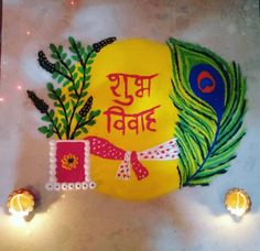 a decorated plate with peacock feathers on it and candles in front of the sign that says happy diwali