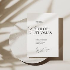 a white plate sitting on top of a table next to a paper with the words choloe thomas written on it