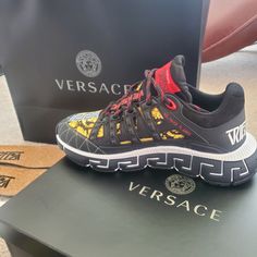 Futuristic Design That Fuses The House’s Codes With Lightweight Shock-Absorbing Greca Rubber And Eva Outsoles. The Trimmed Mesh Upper Is Distinguished By A Hand-Knotted Rope Construction. The Insole Features Dynamic, Screen-Printed Mercury Lettering, And The Tongue Is Embellished With A Printed Versace Logo And A Greca Jacquard Ribbon Pull Tab. Designer Black Sneakers With Logo Print, Luxury Black Sneakers With Logo Print, Designer Running Sneakers, Designer Black Custom Sneakers With Logo Print, Designer Sports Sneakers With Red Sole, Designer Sneakers With Red Sole For Sports, Versace Street Style, Versace Shoes Sneakers, Versace Pattern