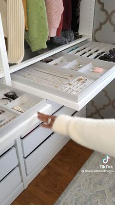 a woman is looking at the drawers in her closet