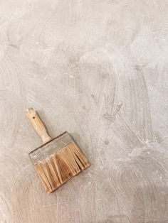 a paint brush sitting on top of a white surface