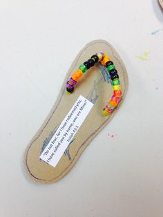 a pair of colorful bracelets sitting on top of a piece of paper