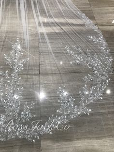 a wedding veil with the word happily married written on it is laying on a wooden floor