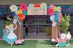 the entrance to alice's on wonderland is decorated with paper flowers and clock decorations