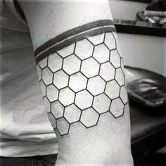 a man with a tattoo on his arm that has hexagons on it