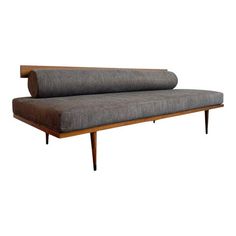 a gray couch sitting on top of a wooden frame