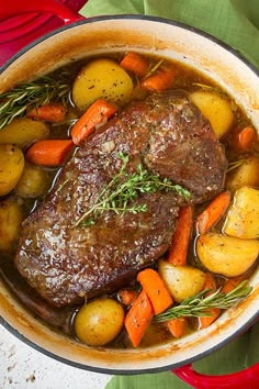 a pot filled with meat and vegetables on top of a stove