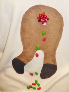 a person wearing a white shirt with a reindeer's nose and candy on it