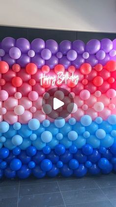 the balloon wall is decorated with colorful balloons