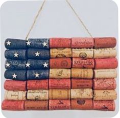 an american flag made out of wine corks hanging from a rope on a wall