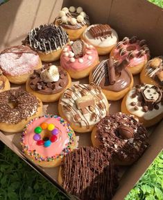 a box filled with lots of different flavored donuts