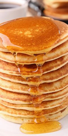 a stack of pancakes on a plate with syrup