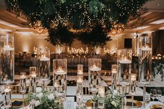 the tables are set up with candles and centerpieces for an elegant wedding reception