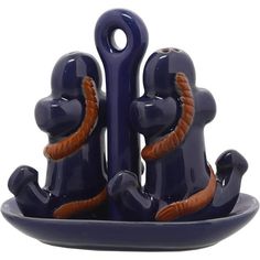 two blue ceramic figurines sitting on top of each other in the shape of an anchor