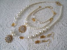 "This lovely jewelry set has a necklace, two bracelets, and matching earrings with cream pearl beads, honey gold Czech glass beads, clear czech glass beads, seed beads, antique gold filigree pendant with rhinestones. 18\" long. Toggle clasp. The bracelets are 7\" long." Elegant Cream Jewelry For Wedding, Vintage Gold Pearl Jewelry, Victorian Pearl Jewelry For Formal Occasions, Elegant Handmade Adjustable Jewelry Sets, Handmade Gold Pearl Jewelry, Cream Pearl Drop Jewelry For Anniversary, Handmade Elegant Round Bridal Necklace, Elegant Handmade Round Bridal Necklace, Victorian Beaded Jewelry Gift