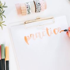 a clipboard with the word practice written on it, surrounded by markers and pencils