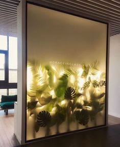 a glass wall that has plants on it