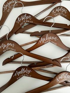 a bunch of wooden hangers with names on them