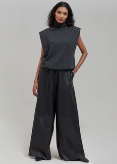 Color: Black Midweight smooth leather Relaxed fit Wide leg Elasticated waistband Side seam hip pockets Slip-on style Unlined 100% Lamb Skin Dry Clean By The Frankie Shop. Made in India Sleek Black Wide-leg Leather Pants, Black Leather Wide-leg Pants, Modern Black High-waisted Leather Pants, High-waisted Leather Pants For Business Casual, Luxury Black Leather Pants For Work, Classic Black Wide Leg Leather Pants, Elegant Black Wide-leg Leather Pants, Modern Leather Pants With Pockets For Work, Black Leather Business Casual Pants